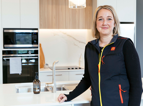Emma, a Noel Leeming Commercial specialist, in a newly built kitchen