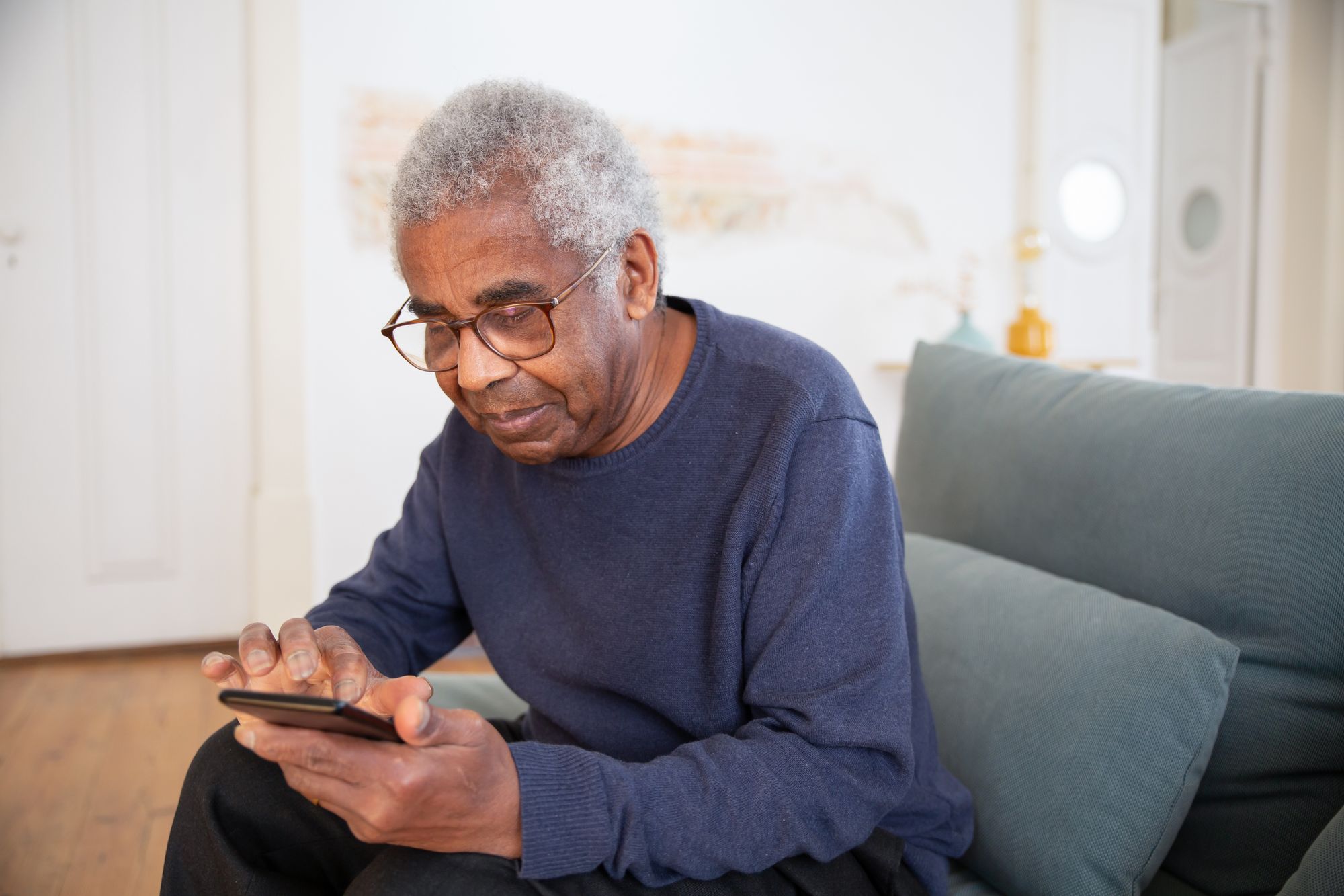 Resident using a smartphone in a modern living space